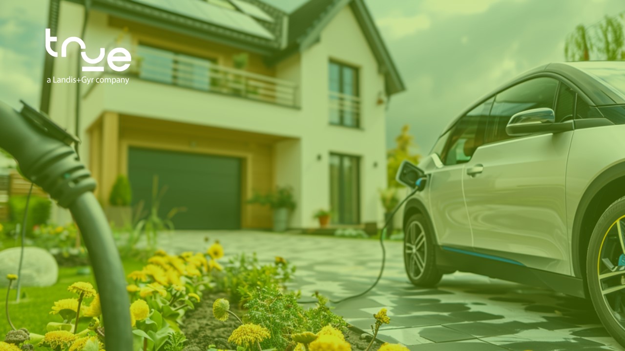 An EV charging in front of a house on a spring day.